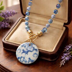 Round Ceramic Horse themed pendant hanging from a Stirrup toggle clasp All Srung